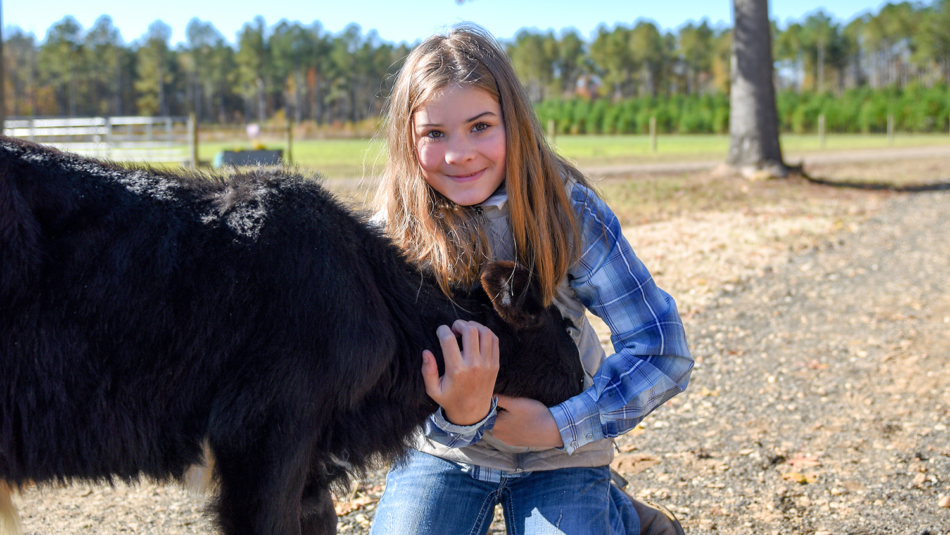 NC 4-H's Sadie, shown here hugging a rescued calf, helps after Hurricane Florence