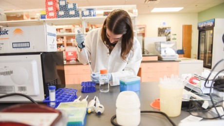 Biochemistry student with pipette