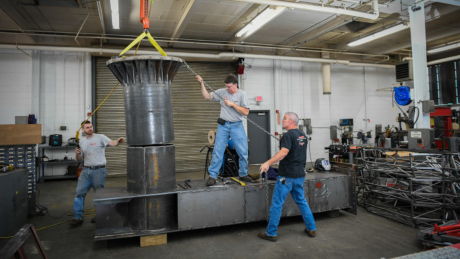 BAE's Neil Bain works with the machine shop crew.