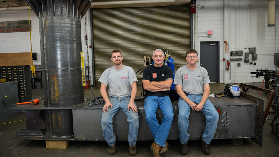 BAE's Neil Bain and two members of his team.