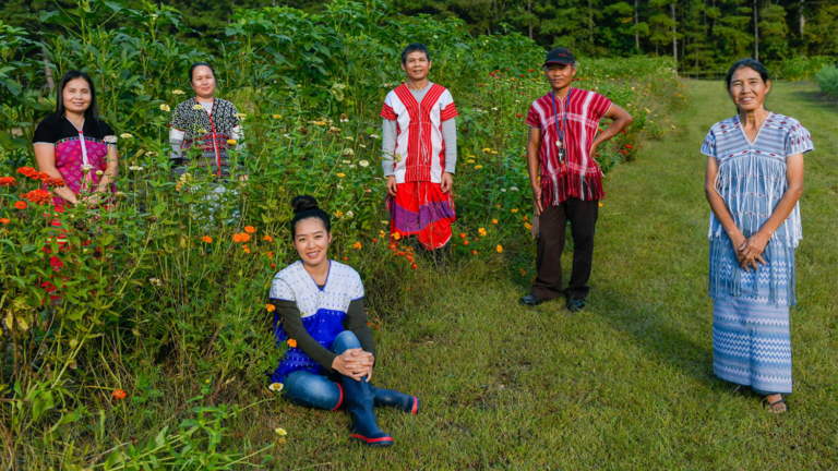 Sa Tin, Kee Lar, Htoo Saw Ywa, Ker Kapaw Shee and Htoo Paw Loe stand in the garden with Kree Paw Sain, seated.