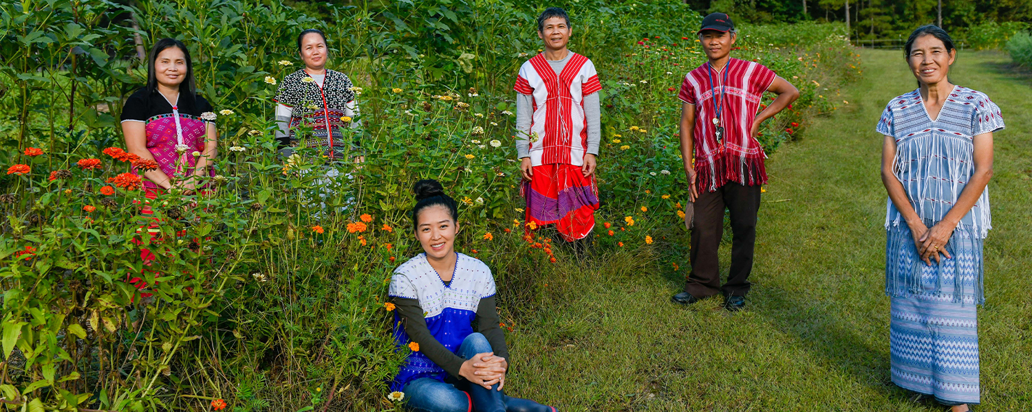 Sa Tin, Kee Lar, Htoo Saw Ywa, Ker Kapaw Shee and Htoo Paw Loe stand in the garden with Kree Paw Sain, seated.